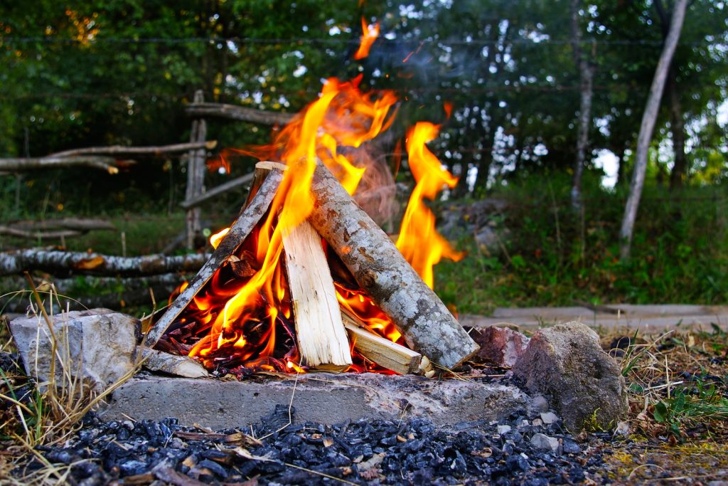 campfire set up in a pyramid formation that is burning