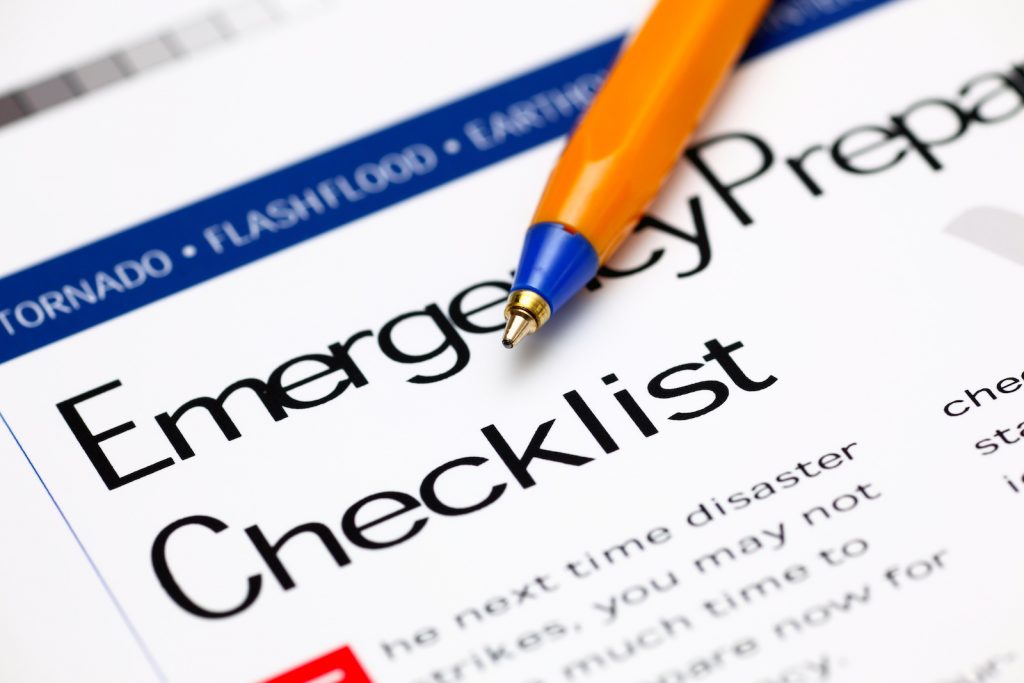 Emergency plan checklist with a pen sitting on it