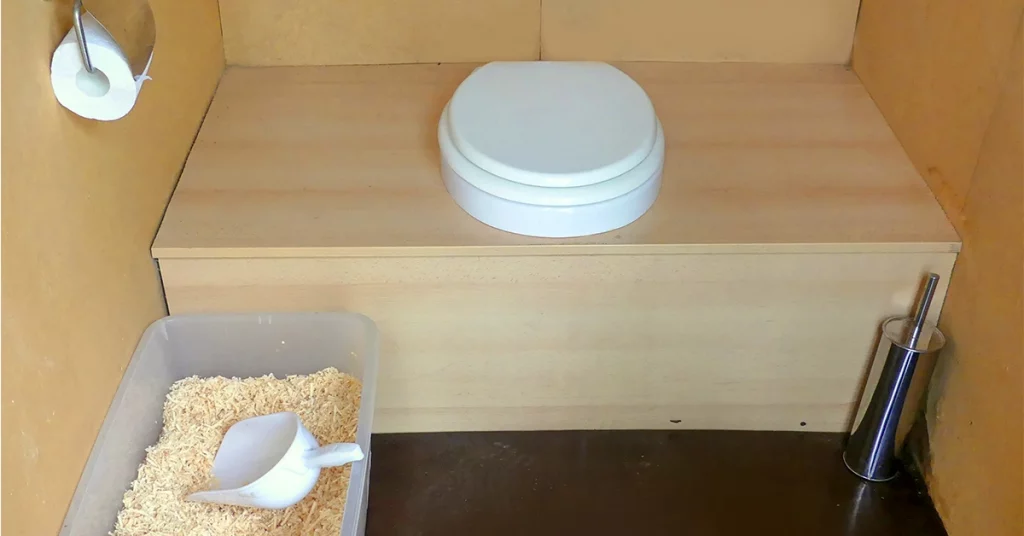 composting toilet with sawdust and a scoop