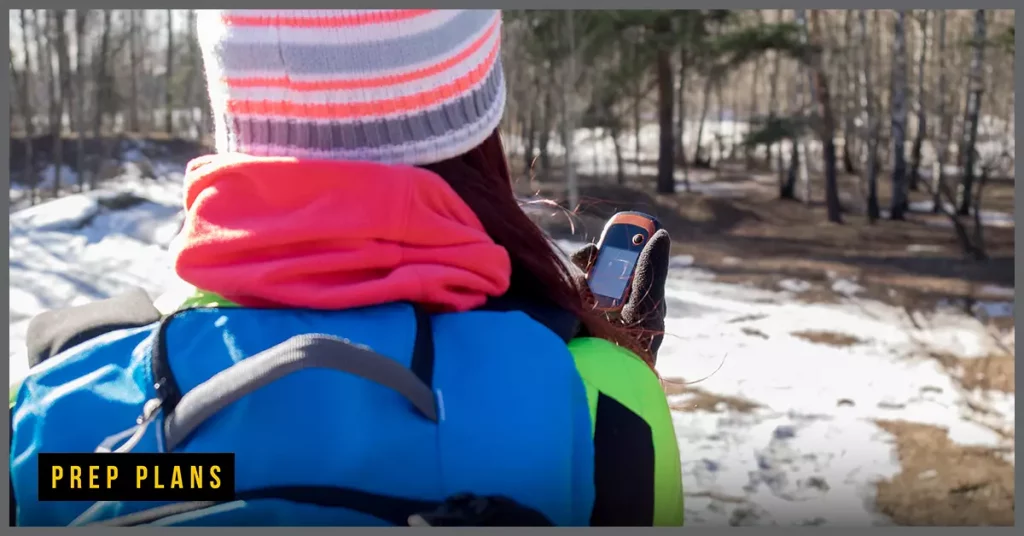 woman using a satellite phone to talk to family members in the forest