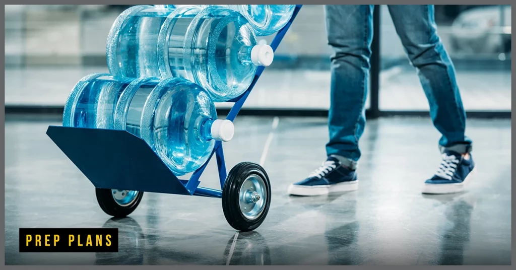 five-gallon water bottles on a dolly