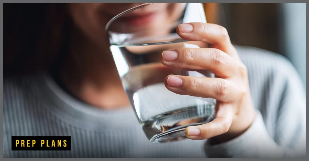 person drinking water from a glass